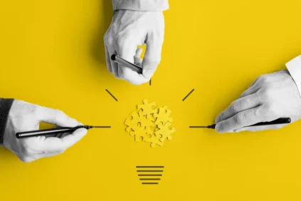 Image of 3 hands and yellow puzzle pieces