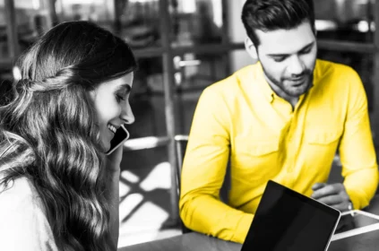 Image of two people looking at screens
