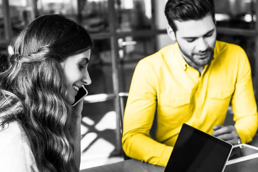 Image of two people looking at screens