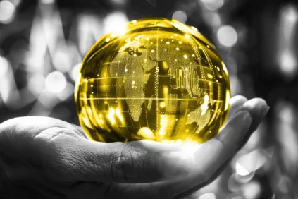 A hand holding a yellow globe