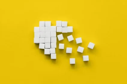 Small wooden squares spreading out from a cohesive shape