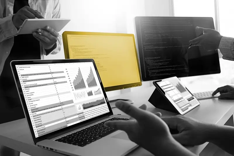 laptop and monitors on a desk