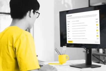 Man looking at monitor with report